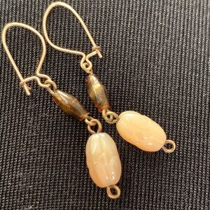 Vintage earrings - carved stone and amber glass with golden ear wires.